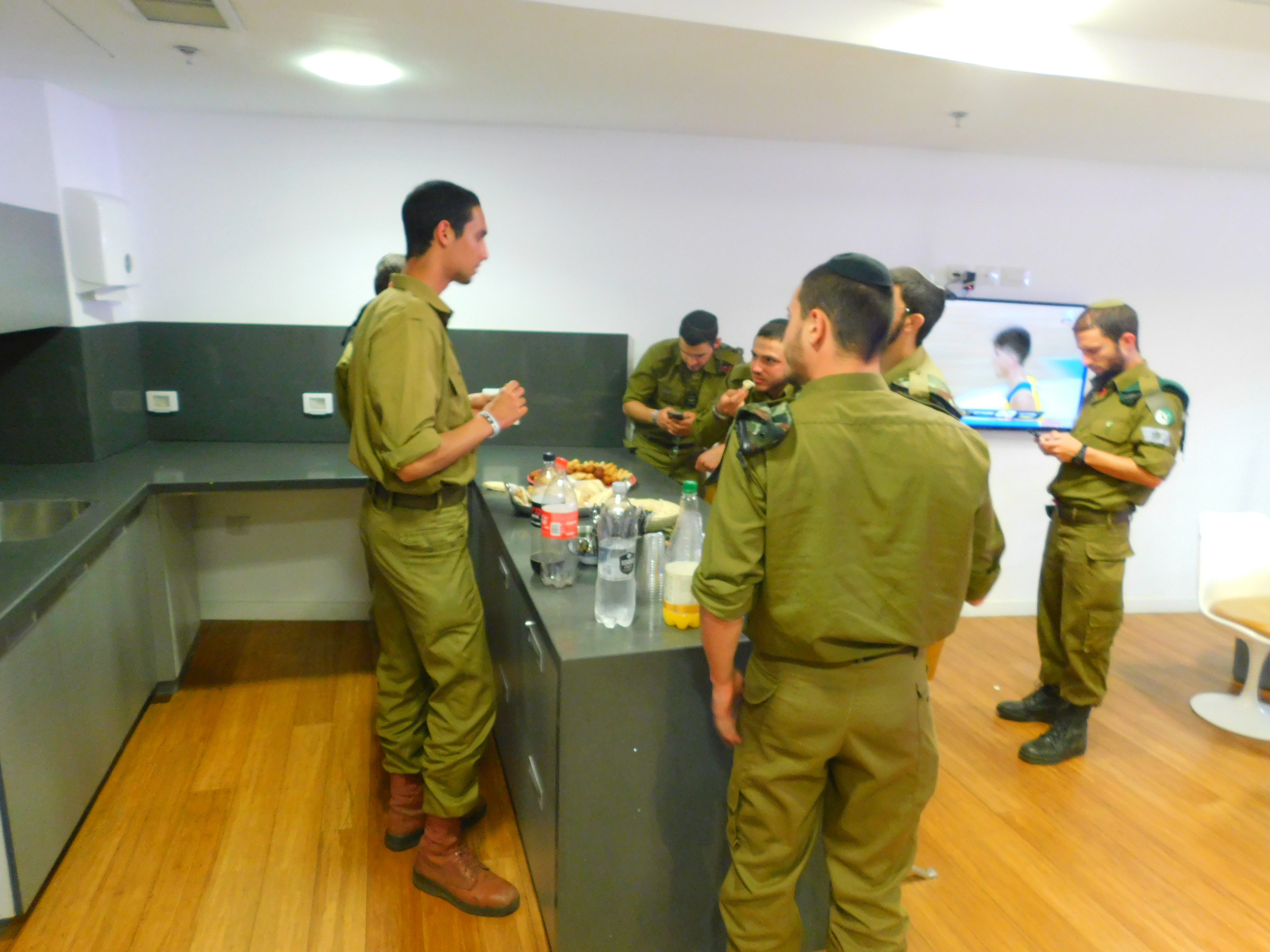 IDF soldiers enjoy the snacks provided at their VIP box at the HaPoel Jerusalem basketball arena.